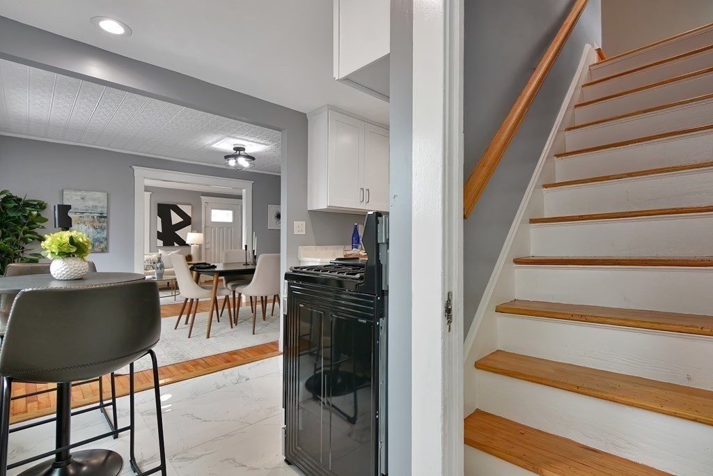 47 Moore Street Lowell, MA 01852 - Photo 17 of 36 a view of a livingroom with furniture and staircase