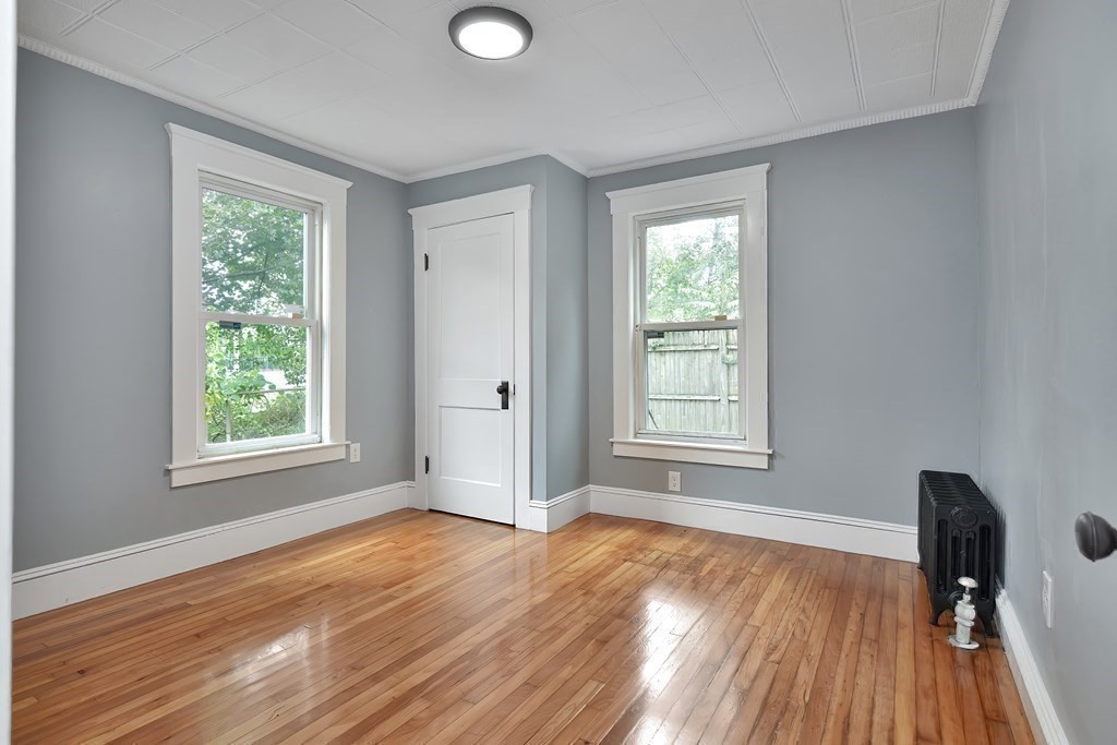 47 Moore Street Lowell, MA 01852 - Photo 19 of 36 a view of an empty room with wooden floor and a window