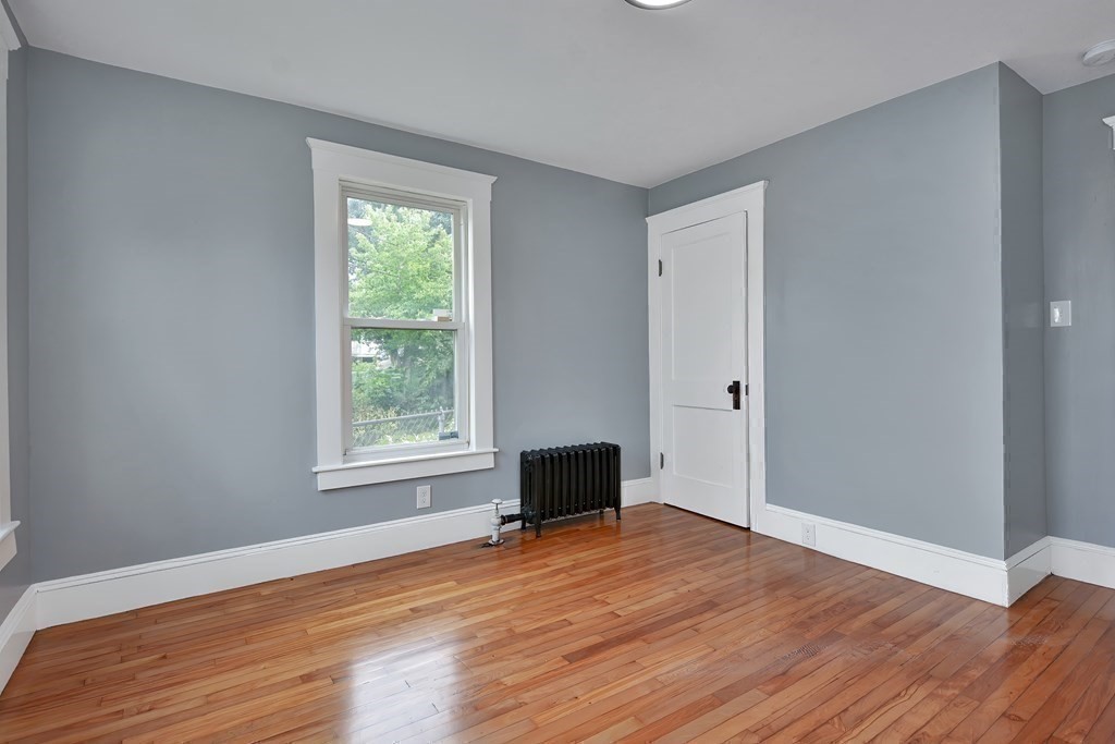 47 Moore Street Lowell, MA 01852 - Photo 21 of 36 a big room with wooden floor a bedroom and windows