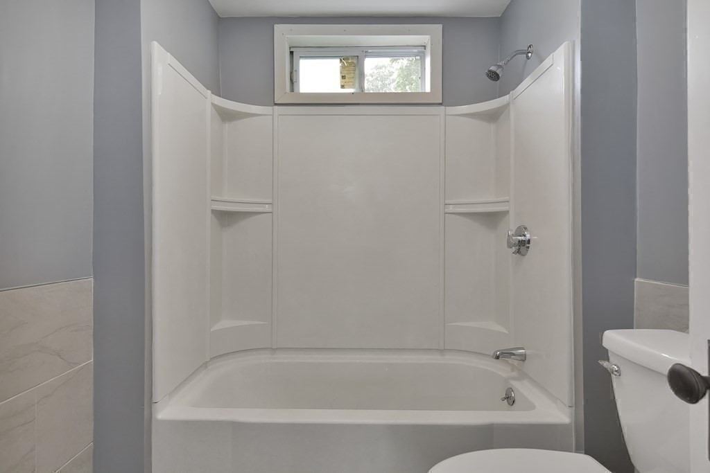 47 Moore Street Lowell, MA 01852 - Photo 23 of 36 a bathroom with bathtub and shower