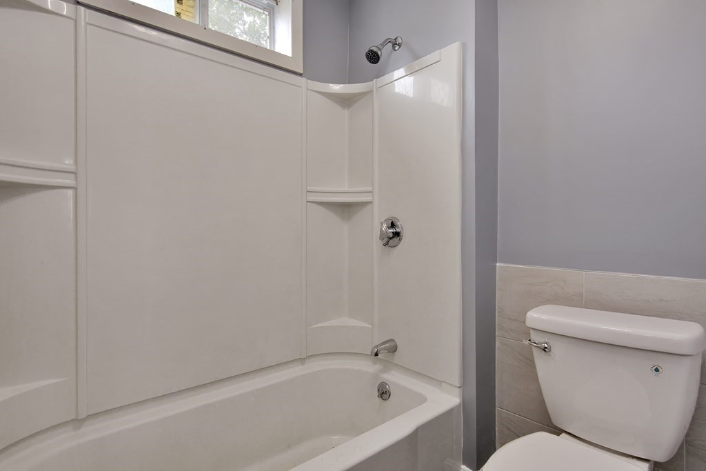 47 Moore Street Lowell, MA 01852 - Photo 24 of 36 a bathroom with a toilet and a bathtub