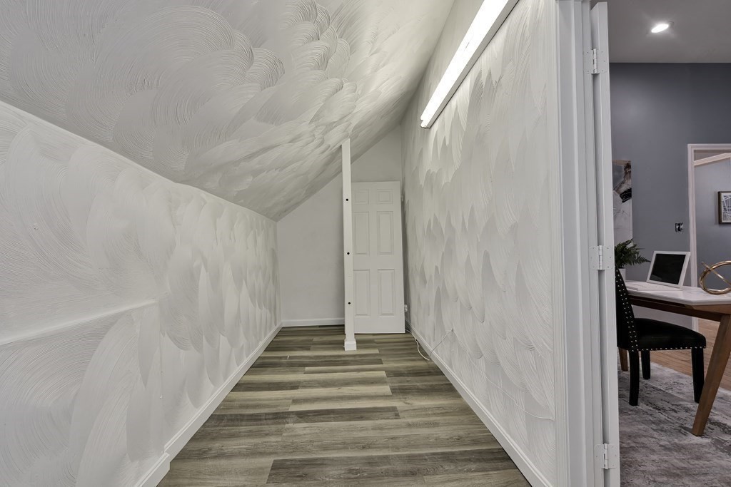 47 Moore Street Lowell, MA 01852 - Photo 28 of 36 a view of a hallway with wooden floor and entryway