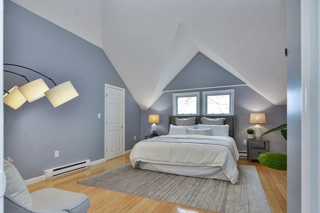 47 Moore Street Lowell, MA 01852 - Photo 30 of 36 a bedroom with a bed and a large mirror