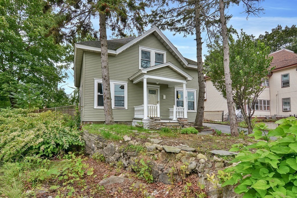 47 Moore Street Lowell, MA 01852 - Photo 3 of 36 a front view of a house with garden
