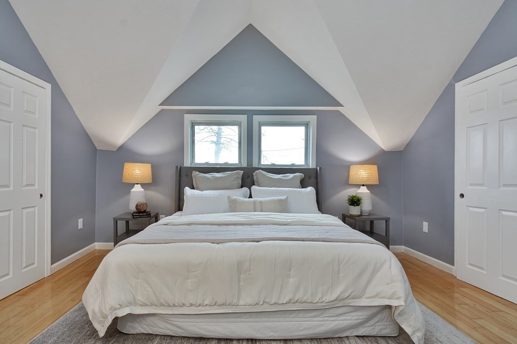 47 Moore Street Lowell, MA 01852 - Photo 31 of 36 a bedroom with a bed and a lamp