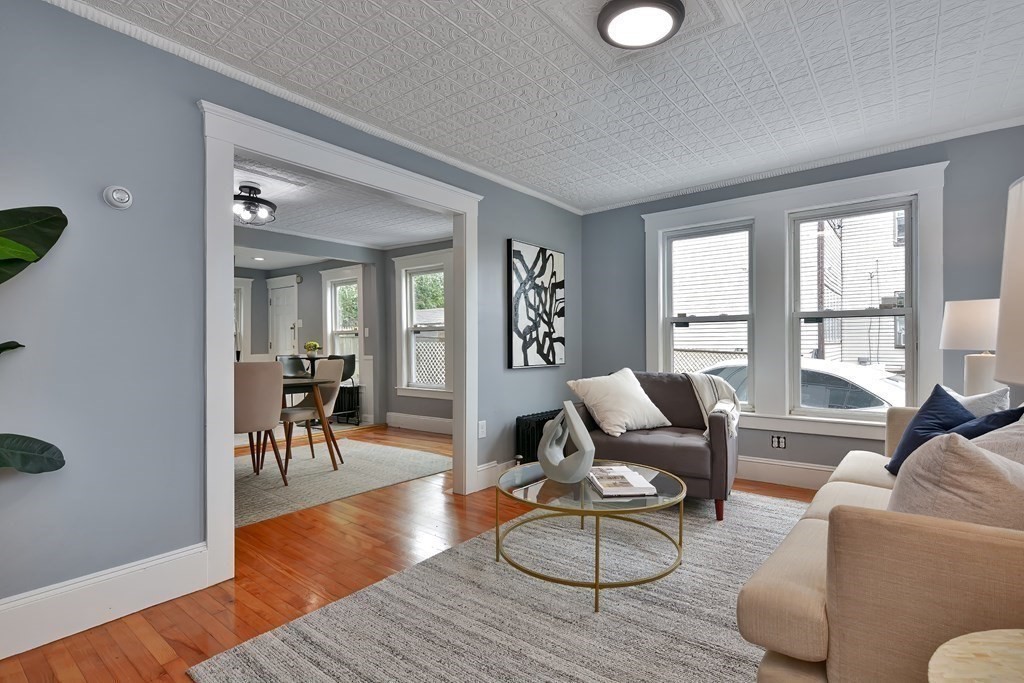 47 Moore Street Lowell, MA 01852 - Photo 4 of 36 a living room with furniture wooden floor and a large window
