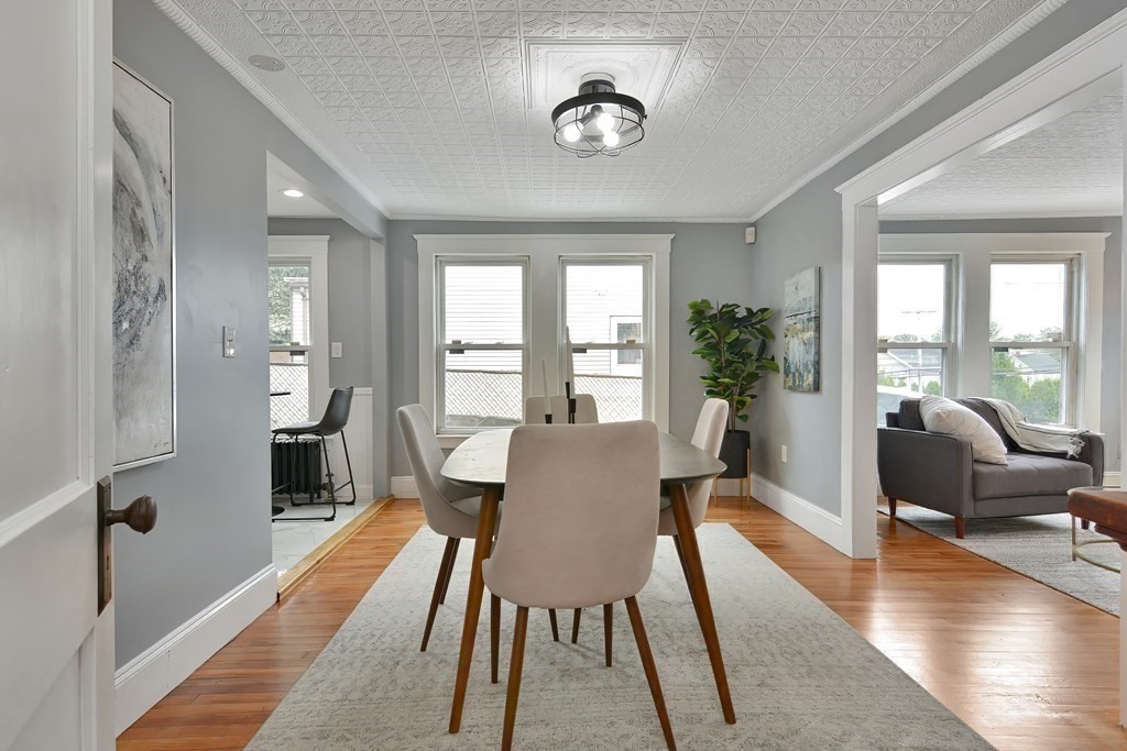 47 Moore Street Lowell, MA 01852 - Photo 8 of 36 a view of a dining room with furniture window and wooden floor