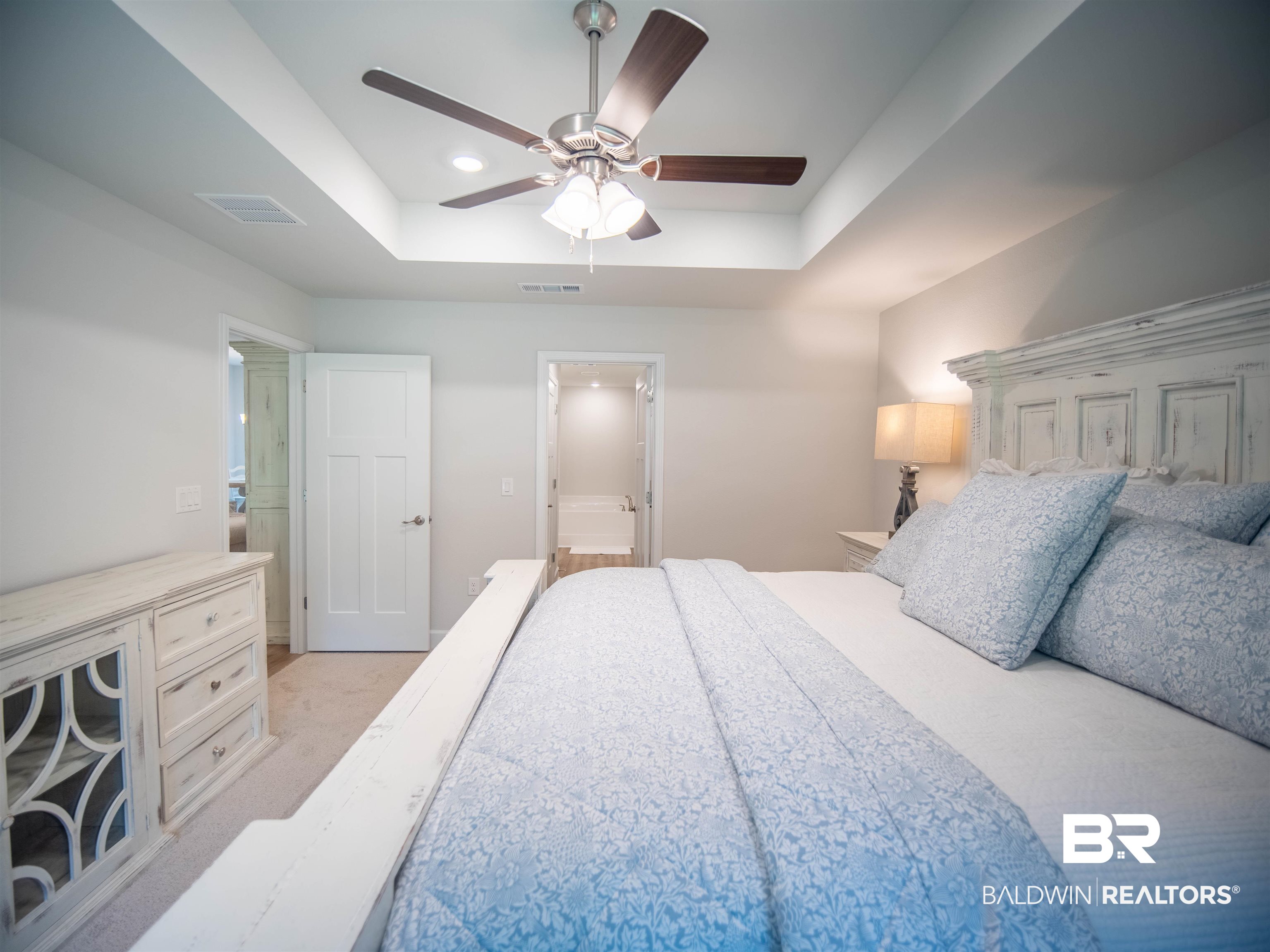 12646 Michigan Avenue Elberta, AL 36530 - Photo 18 of 47 Bedroom with a tray ceiling, light carpet, ceiling fan, and connected bathroom