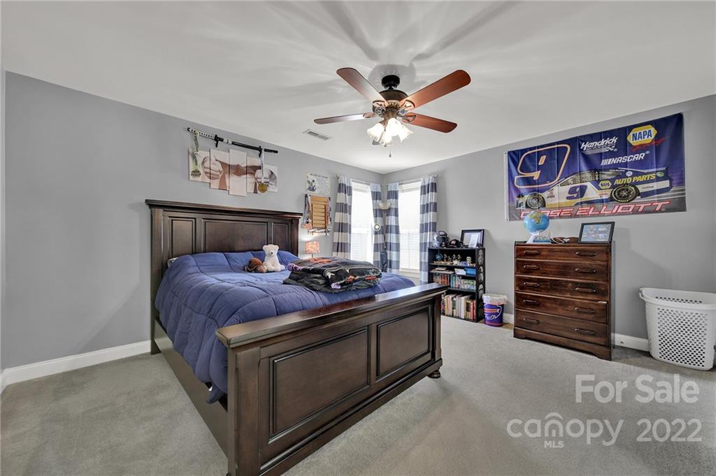 2420 Blueberry Ridge Road Matthews, NC 28105 - Photo 31 of 48 a bed room with a bed and a television