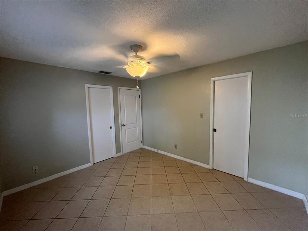 1239 East Ridgewood Street Orlando, FL 32803 - Photo 13 of 14 a view of an empty room and a ceiling fan