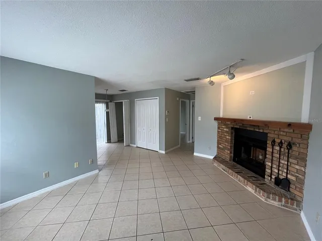 a view of an empty room with a fireplace