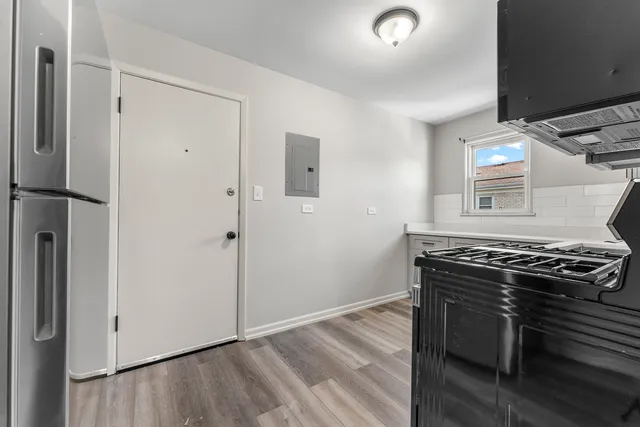 a kitchen with a stove and a refrigerator
