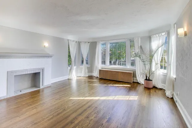 a living room with furniture a flat screen tv and a large window