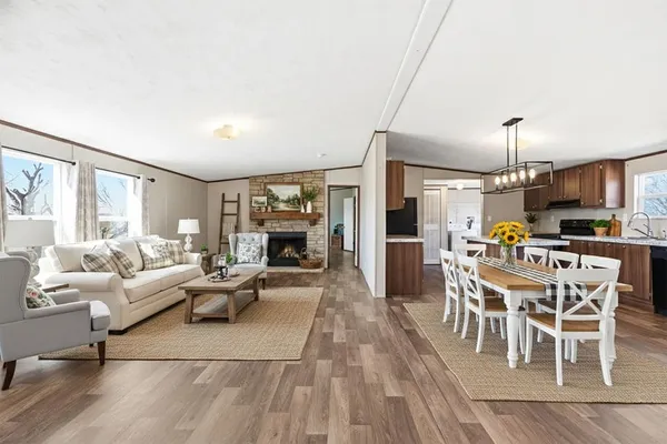 a living room with furniture a dining table and a fireplace