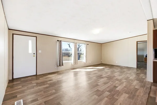 a view of kitchen with stove and cabinets