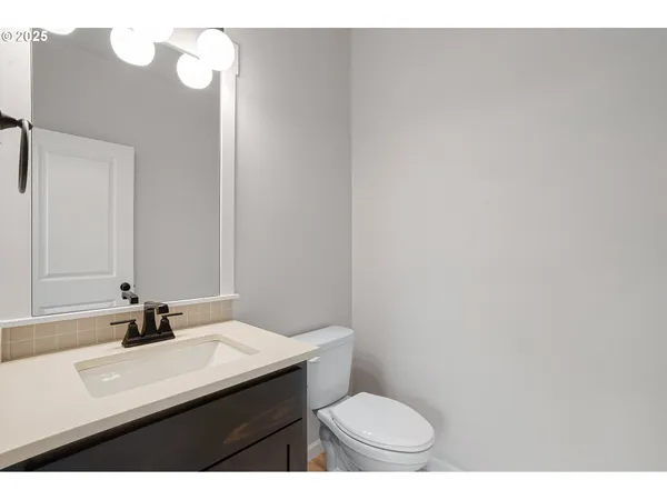 a bathroom with a sink a toilet and mirror