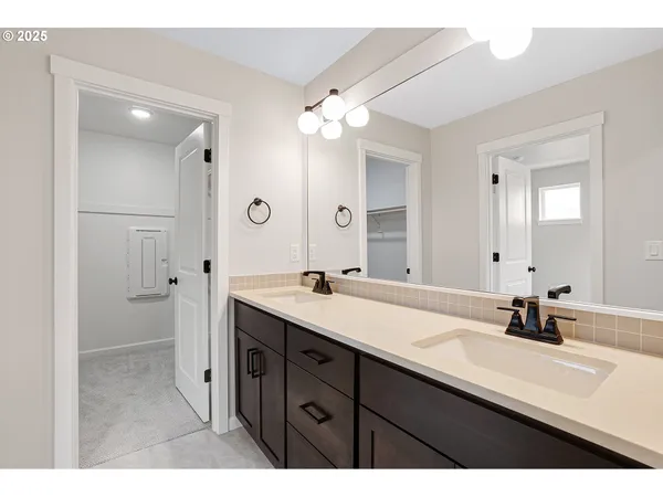 a bathroom with a sink double vanity and a mirror