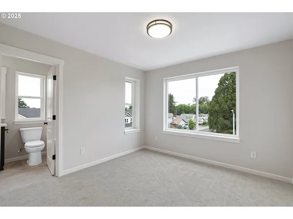 a big room with white walls and windows