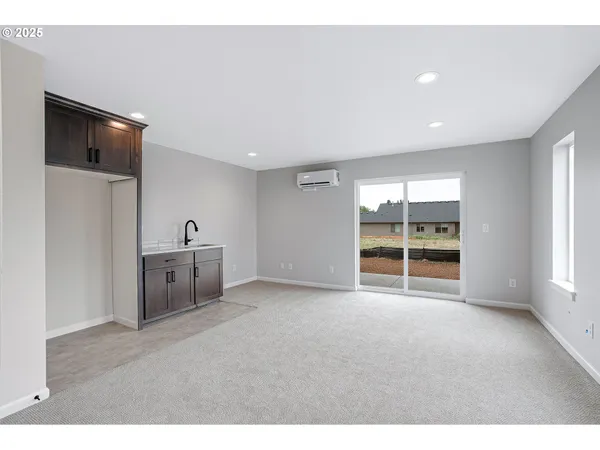 a view of a livingroom with an empty space and a window