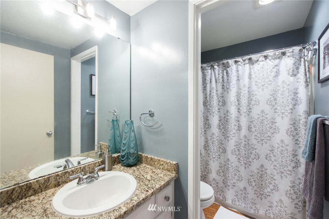 7429 Old Redmond Road, Unit 324 Redmond, WA 98052 - Photo 22 of 25 a bathroom with a granite countertop sink toilet and shower