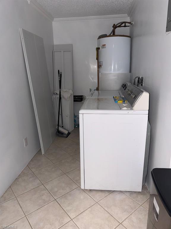 5395 Treetops Drive, Unit I Naples, FL 34113 - Photo 18 of 18 Laundry area featuring a top-load washing machine, a water heater, and light-toned tile flooring