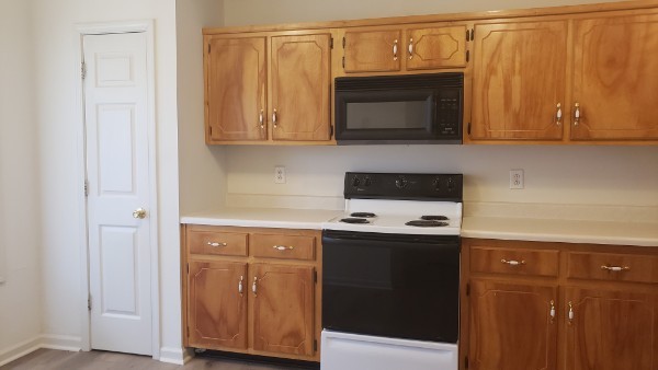235 State Line Road Oak Grove, KY 42262 - Photo 5 of 18 a kitchen with stainless steel appliances granite countertop a stove and a microwave with wooden cabinets