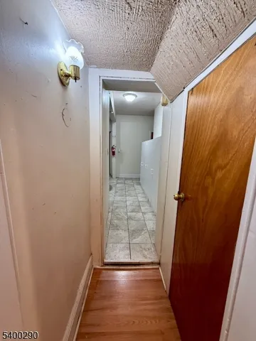 a view of a hallway view with wooden floor and staircase