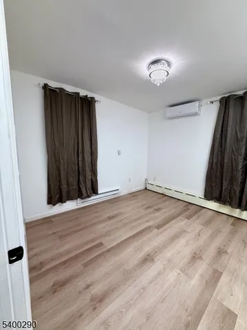 a view of a room with wooden floor