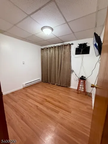a room with wooden floor and gym equipment