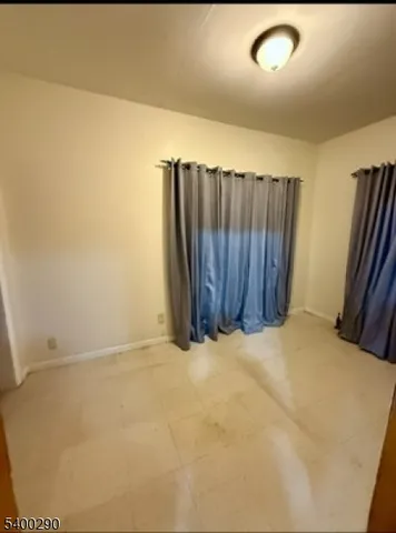 a view of an empty room with wooden walls