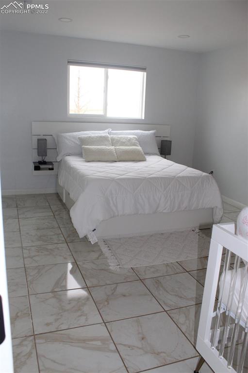 425 Weissenfluh Road Yoder, CO 80864 - Photo 19 of 24 a spacious bedroom with a bed and a window