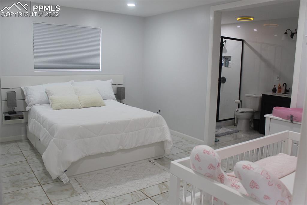 425 Weissenfluh Road Yoder, CO 80864 - Photo 20 of 24 a bedroom with a bed and a couch