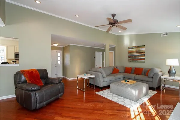 a living room with furniture and a ceiling fan