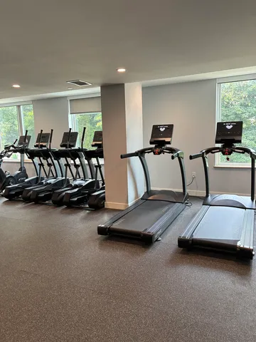 a room with gym equipment and a window