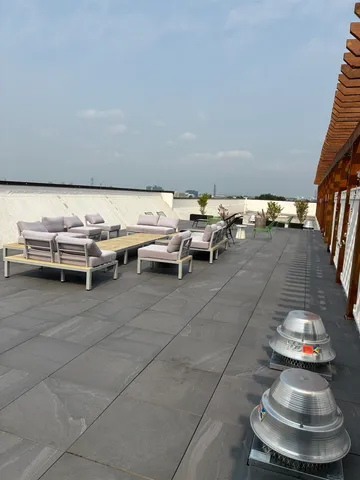 a view of a couches and dinning table in patio