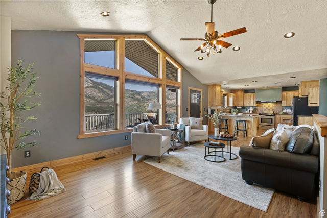 2013 North River View Road Huntsville, UT 84317 - Photo 11 of 53 Living area featuring a mountain view, a high textured ceiling, ceiling fan, light wood-type flooring, and recessed lighting