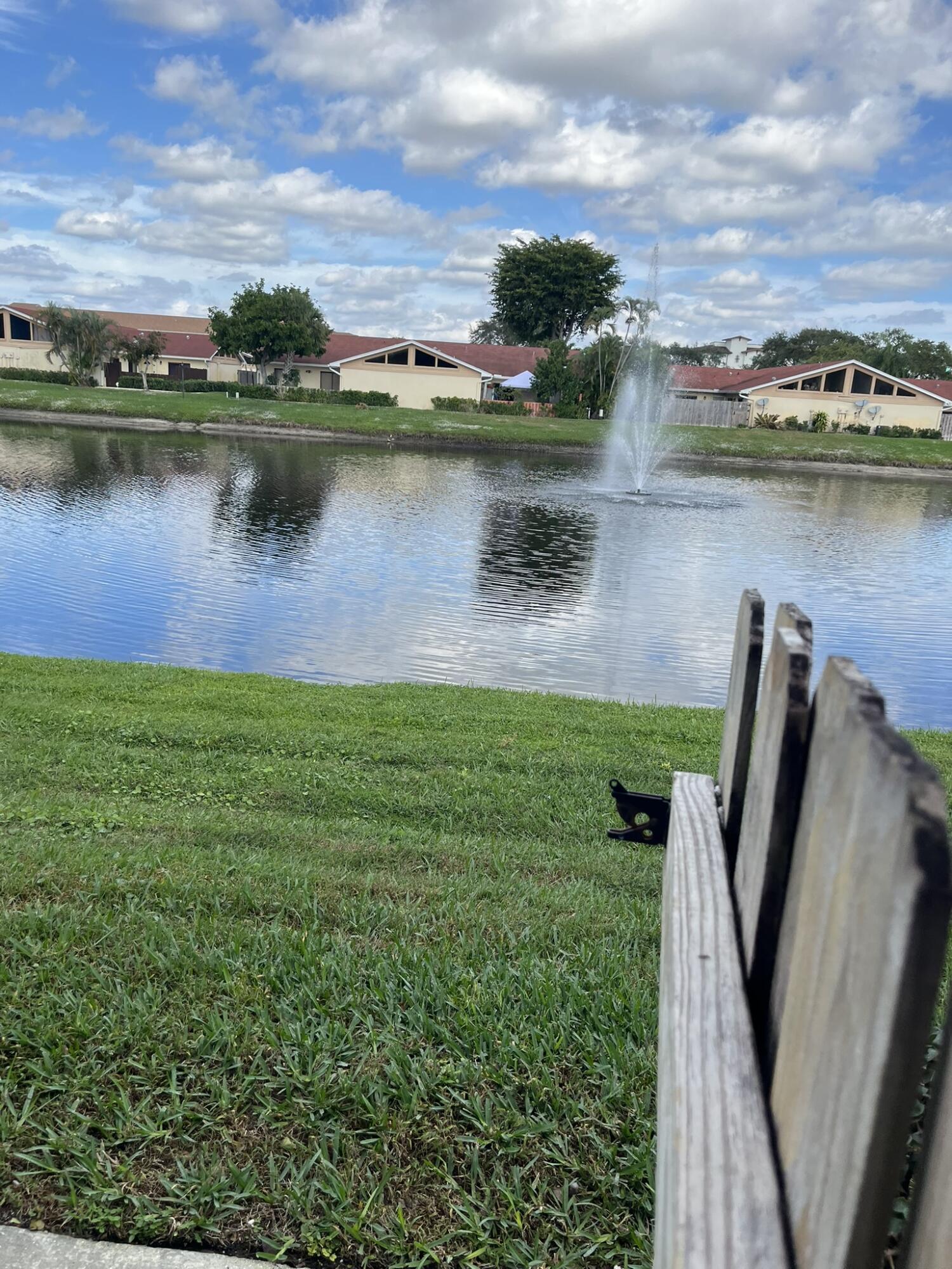 an aerial view of a house with outdoor space lake view and houses with swimming pool