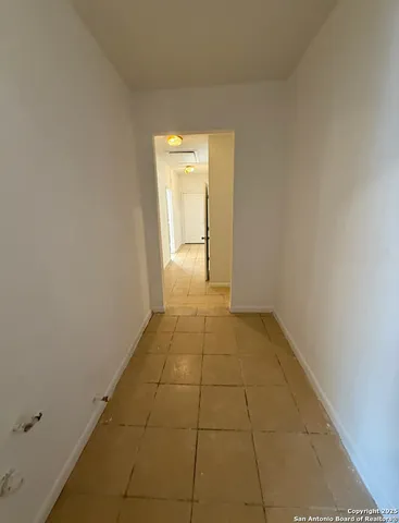 a view of storage and utility room with racks on the wall