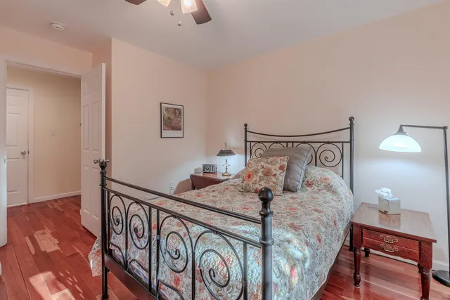 a bedroom with a bed and a lamp on table