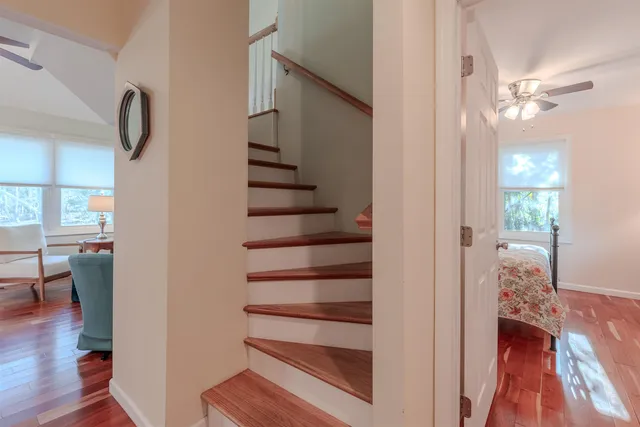 a view of a hallway with wooden floor and staircase