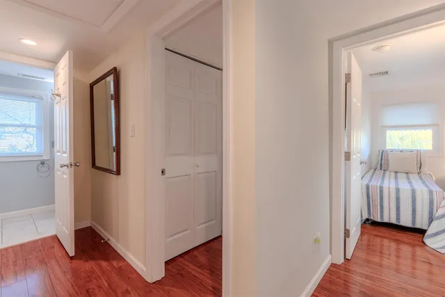 a view of a bedroom with wooden floor