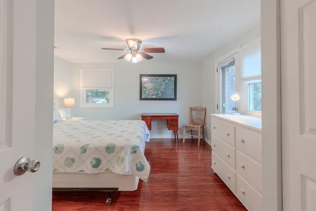 a spacious bedroom with furniture and a window