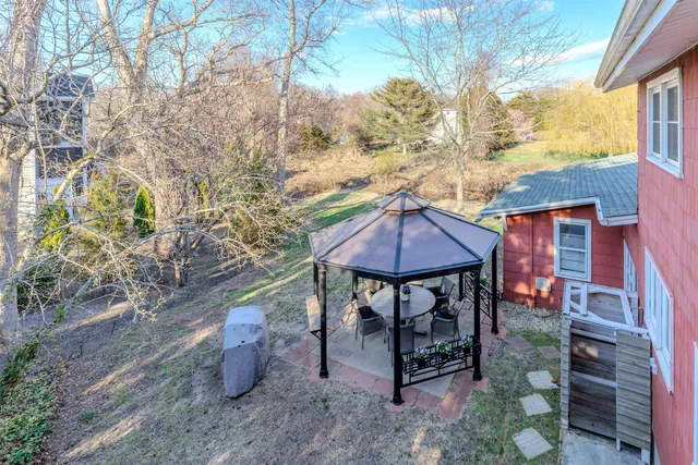 a view of a chairs and table in the backyard