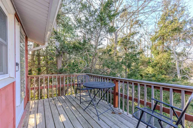 a view of balcony with wooden floor and fence