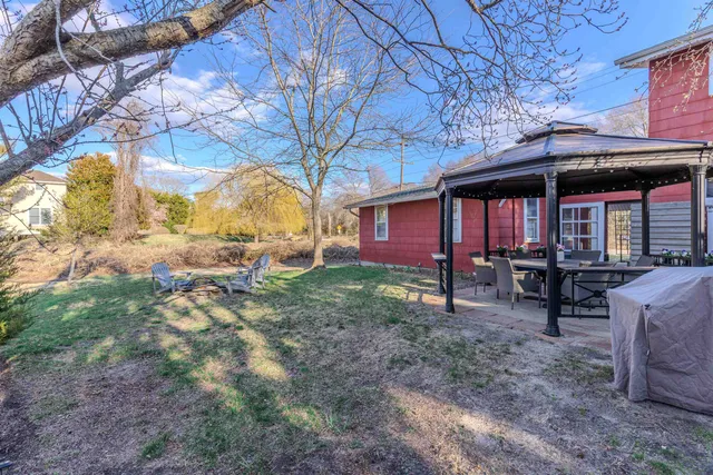 a view of a house with a yard and sitting area