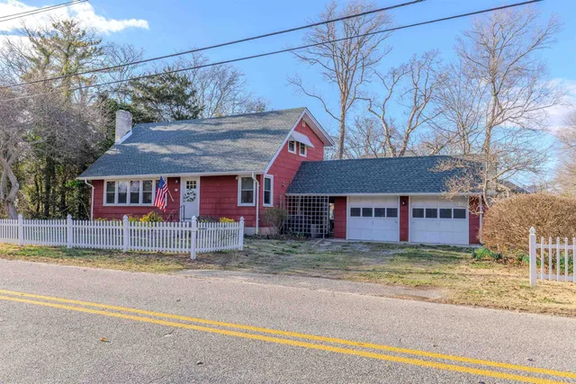 a view of a house with a patio and a yard