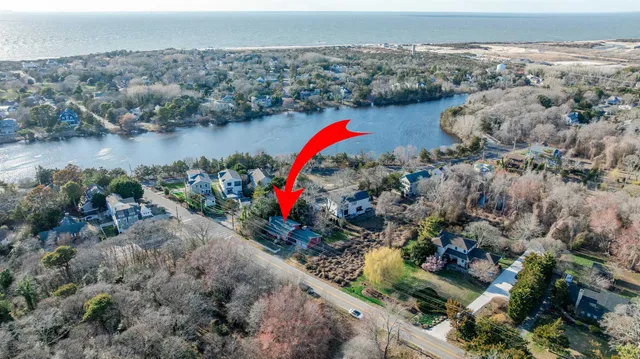 an aerial view of a houses with a lake