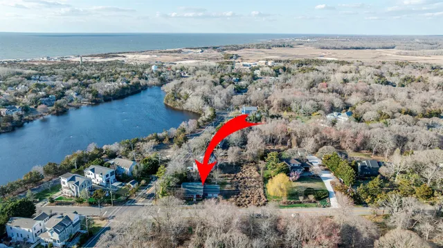 an aerial view of house yard and ocean