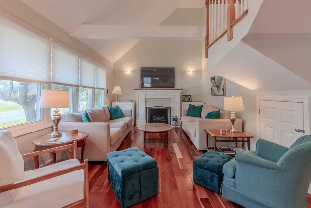a living room with furniture fireplace and a flat screen tv