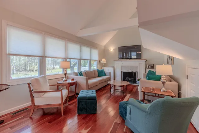 a living room with furniture fireplace and window